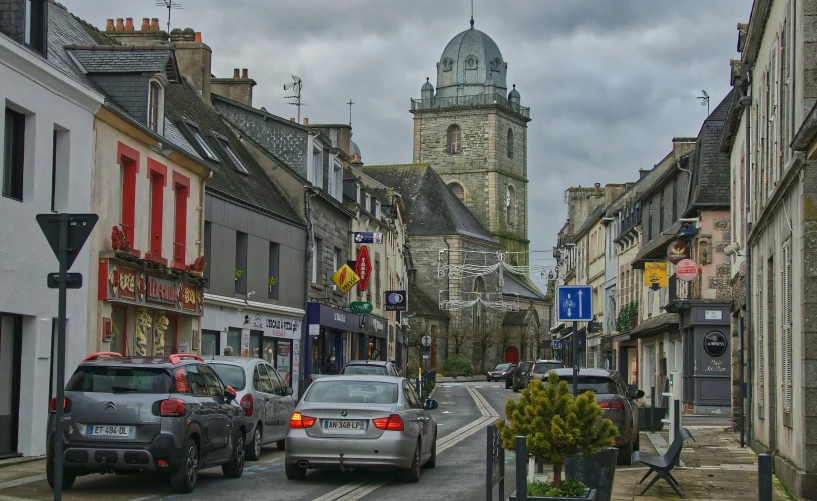 a city street with cars parked along the sidewalks