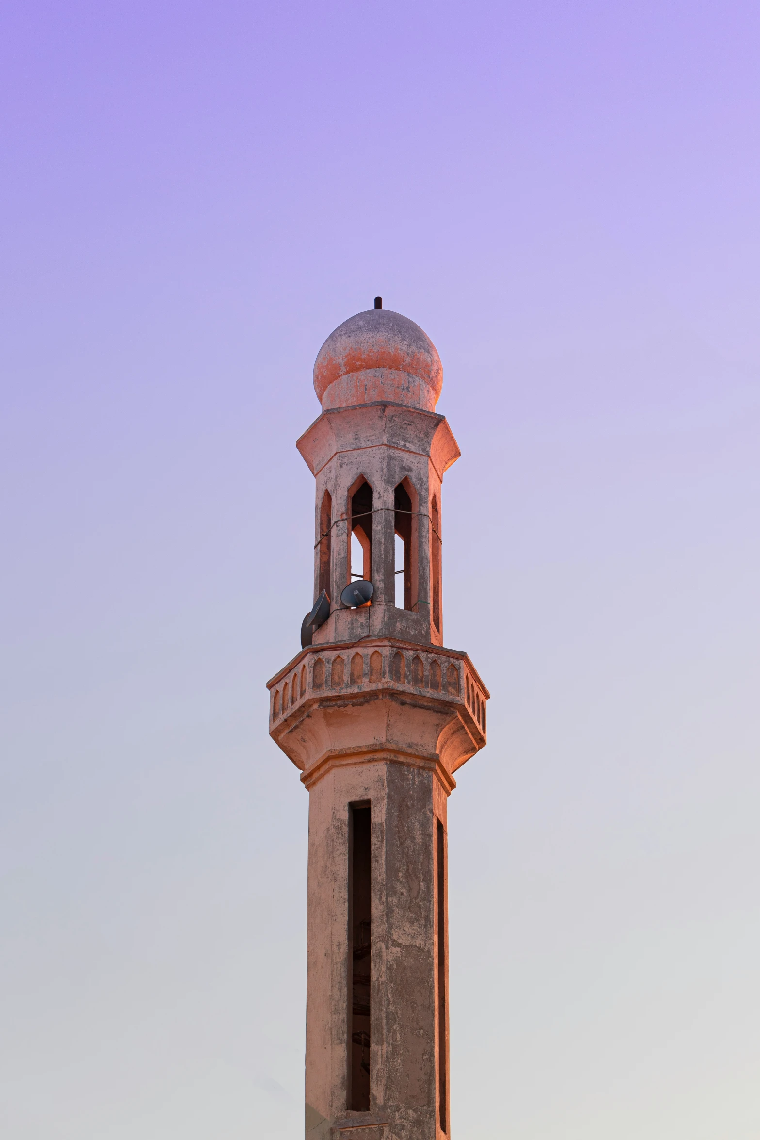 a clock tower with an ornate roof sits beneath a cloudy sky