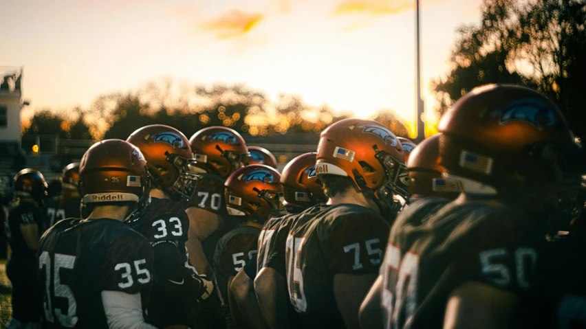 there is a line of football players wearing helmets