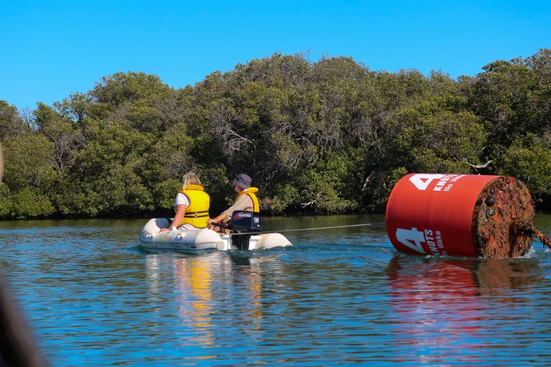 two men on paddle boats paddling in the river