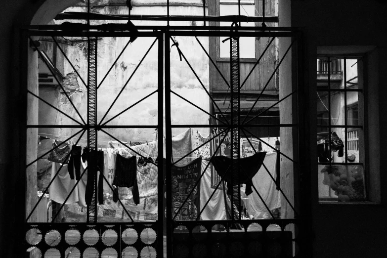 the view through the glass to some laundry hanging in a yard