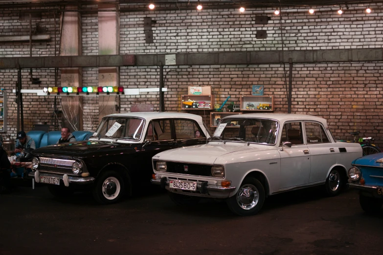 cars are parked in a row along the wall