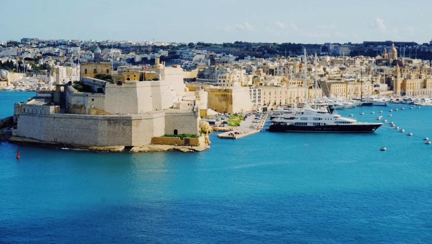 a cityscape in europe next to a body of water