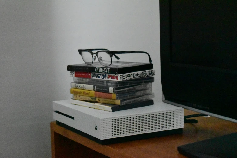 stack of books with glasses sitting on top