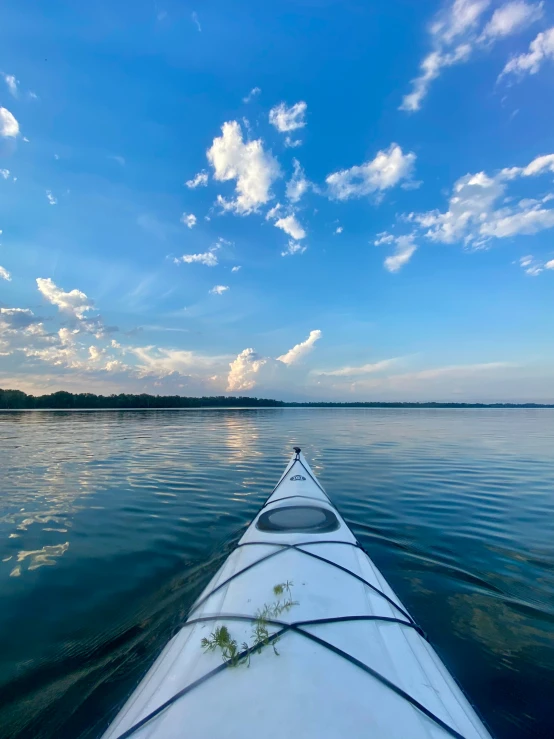 the back end of a white boat on a lake