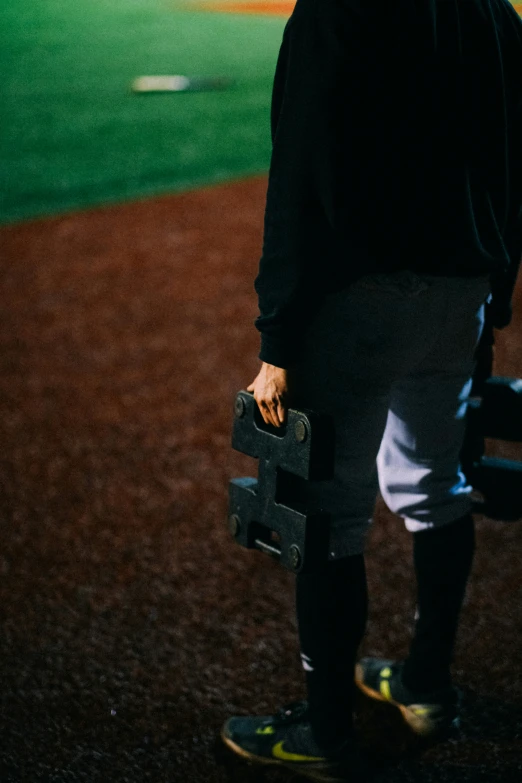 a man with baseball equipment standing on the field