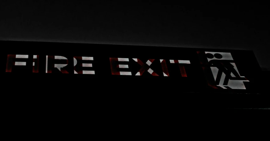 a lit sign is displayed in the dark