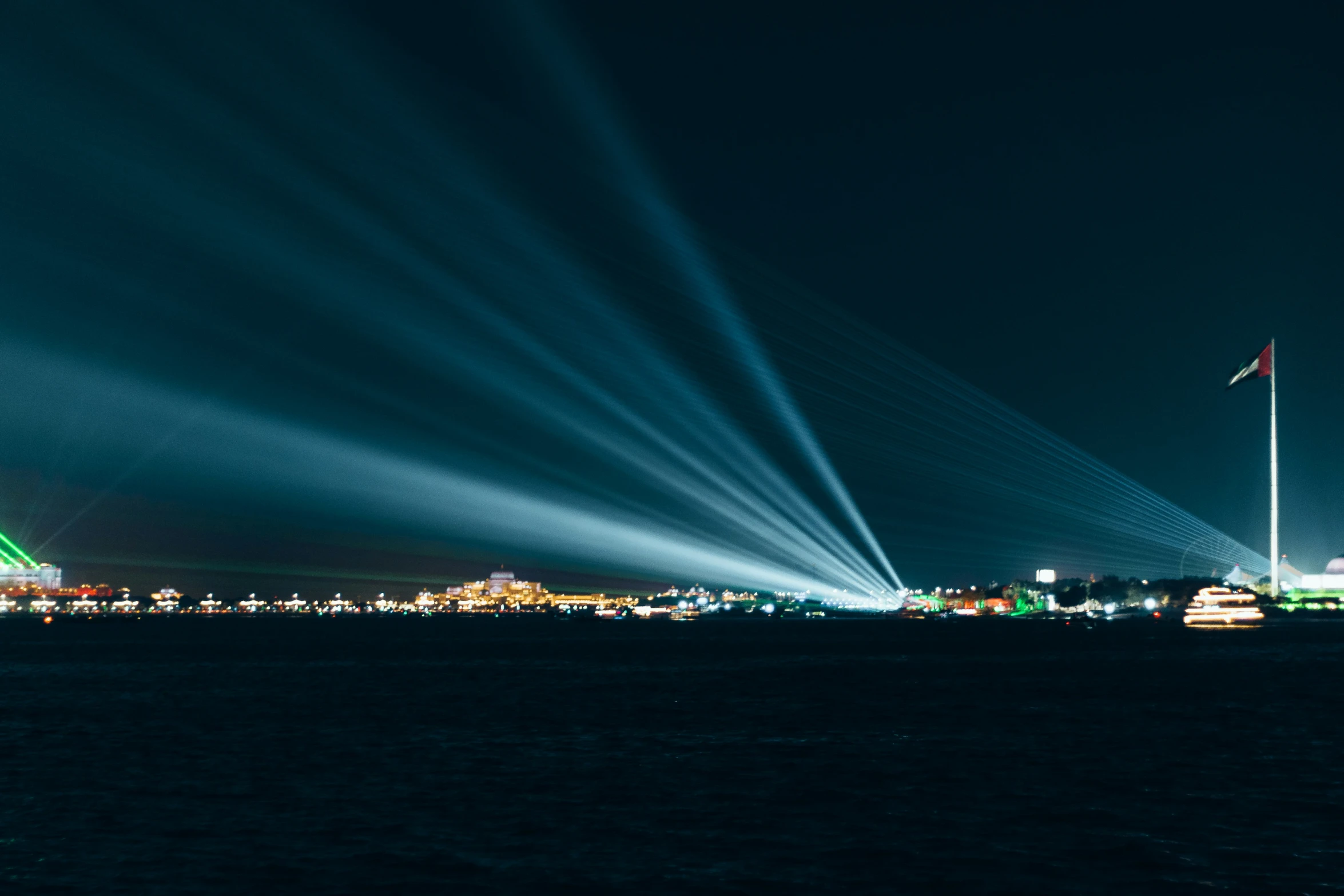 long exposure light beams streak over the night city