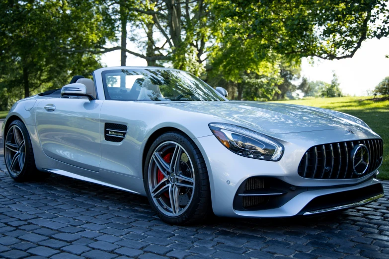 a very fancy mercedes roadster is parked on a street