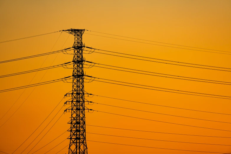 a view of high voltage power lines at sunset