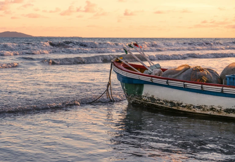 a boat filled with lobsters is floating in the water