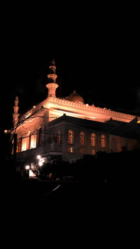 an old church lit up at night, with many windows