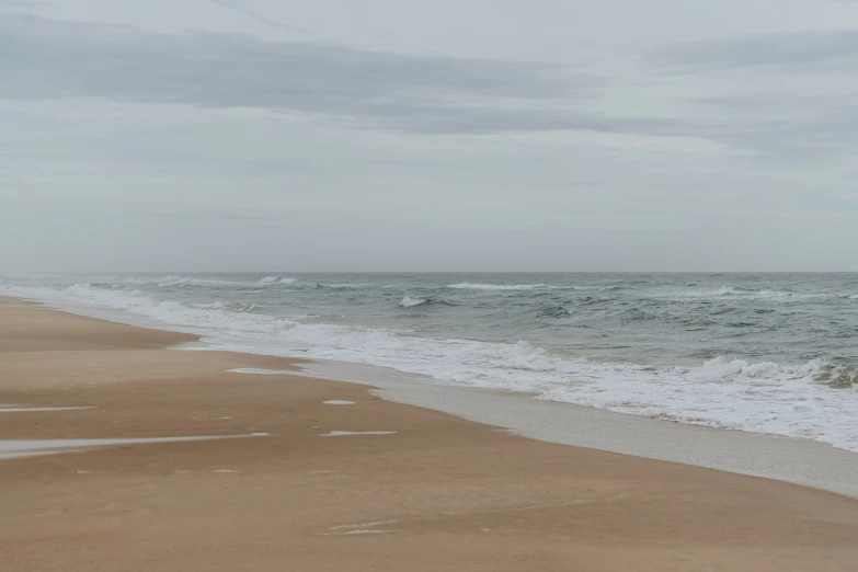 the waves come in at a sandy shore line