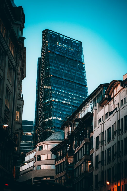 a view of a large skyscr from between two other buildings