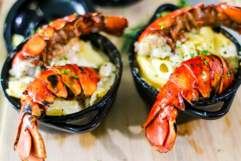 lobster in a small pan with broth on top