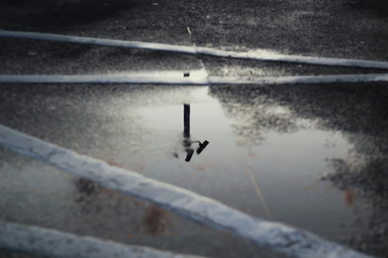 the water is reflecting the pole that is upside down