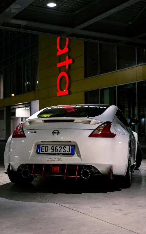 a white sports car parked inside of a building