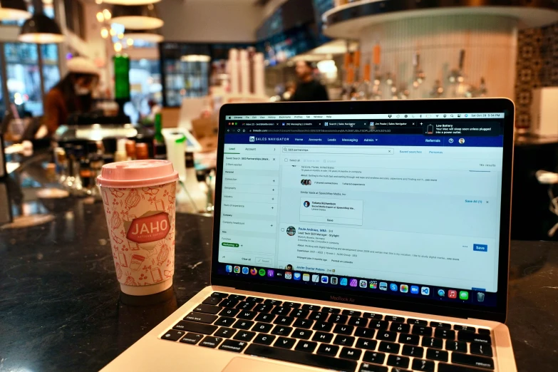 an open laptop sitting on top of a wooden table