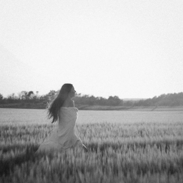 a woman in an open field walking