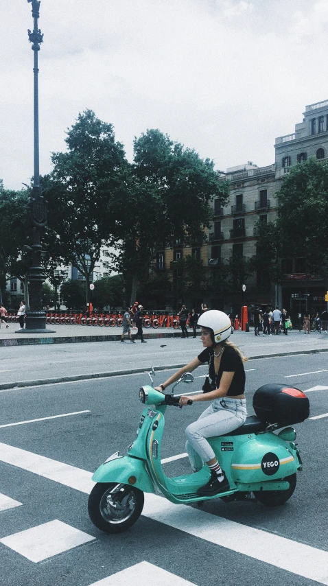 a girl on a motorbike in the middle of the road