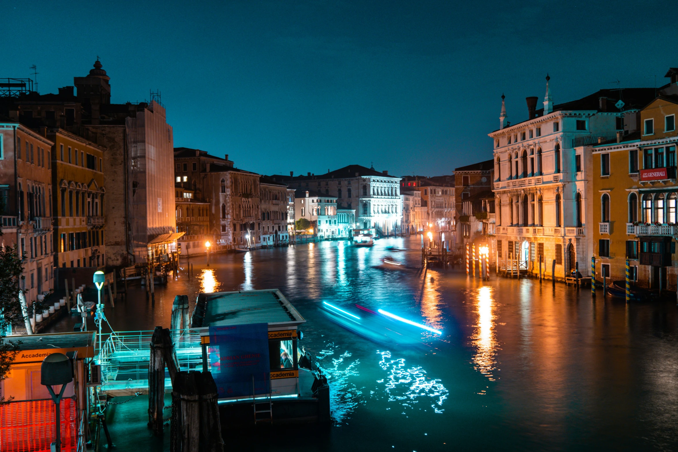 the lights of boats are shining on the water