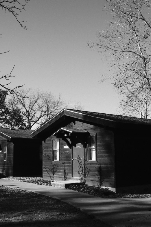 a black and white pograph of a house in winter