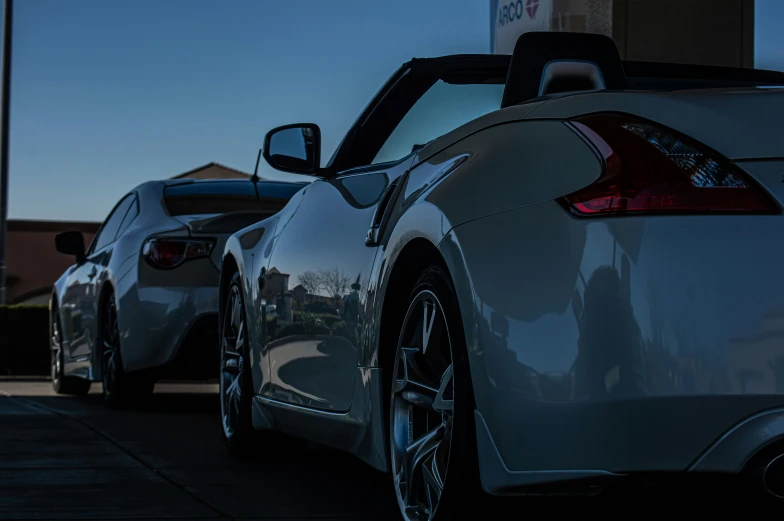 two cars on a road that are parked