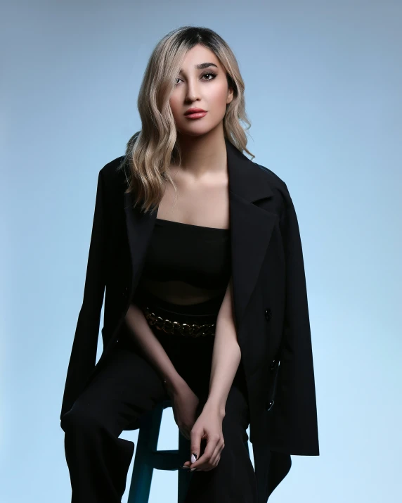 a woman with a black top and coat on