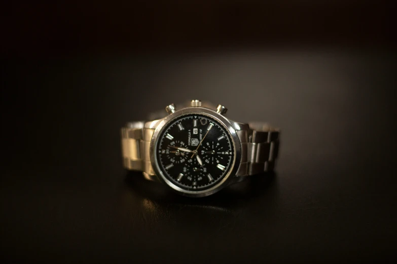 a close up of a watch on a table