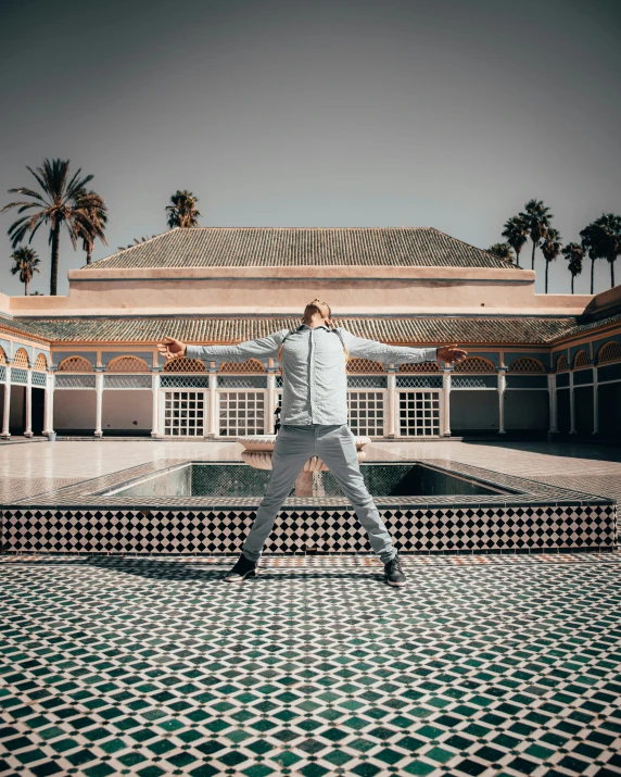 a man standing on top of a mosaic floor