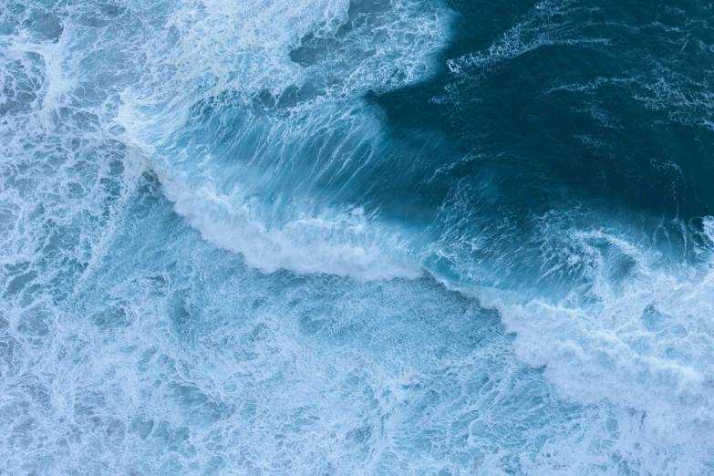 a bird flies over the ocean waves and the water