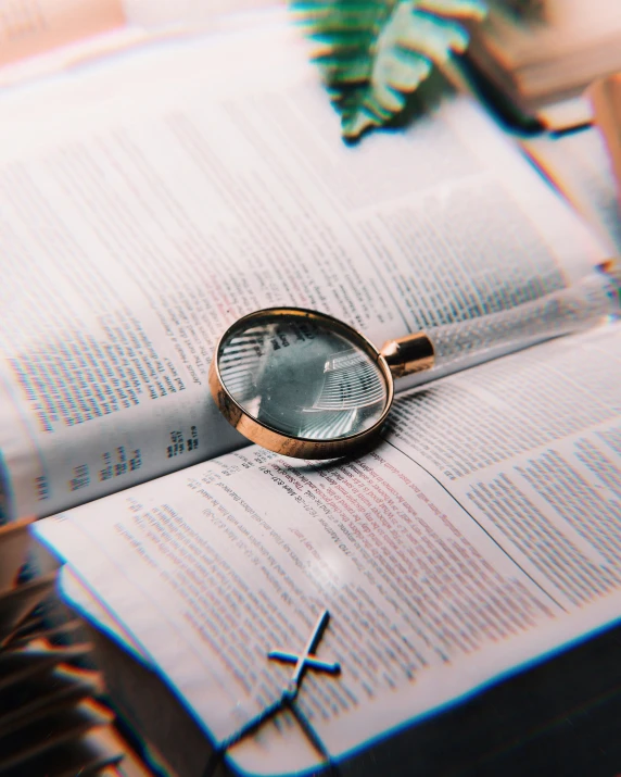 an image of a magnifying glass laying on top of an open book