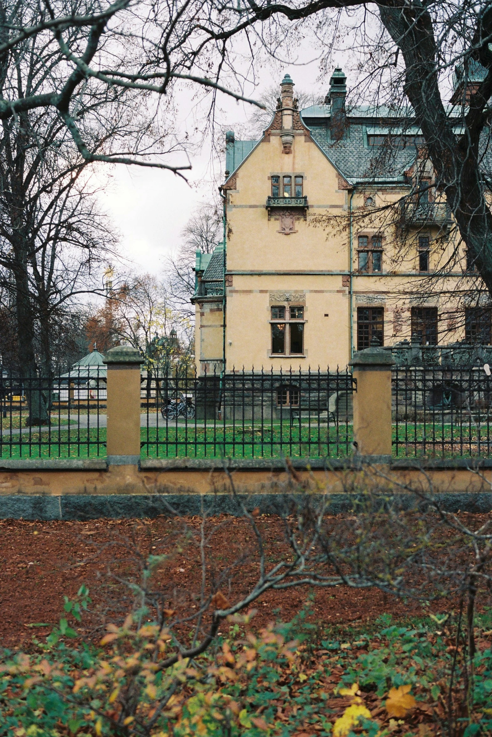 the building is white and has a black fence