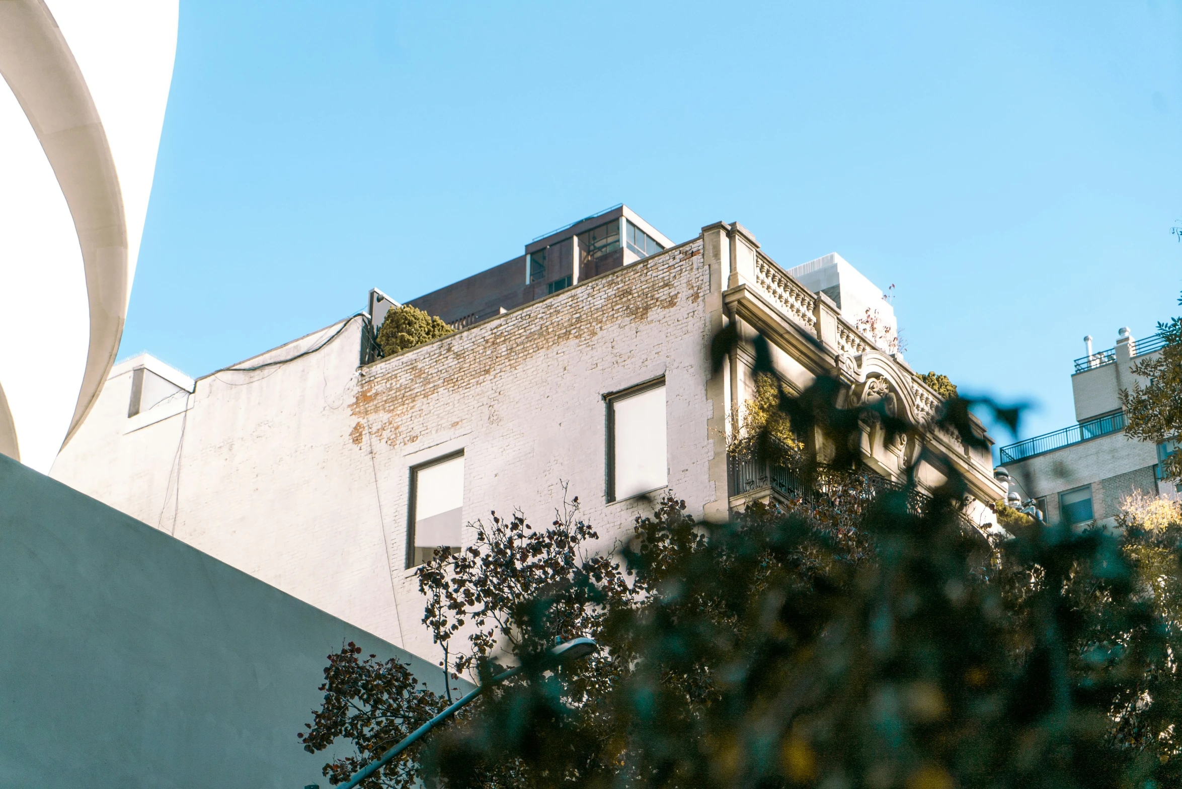 an old building with small windows is against the blue sky