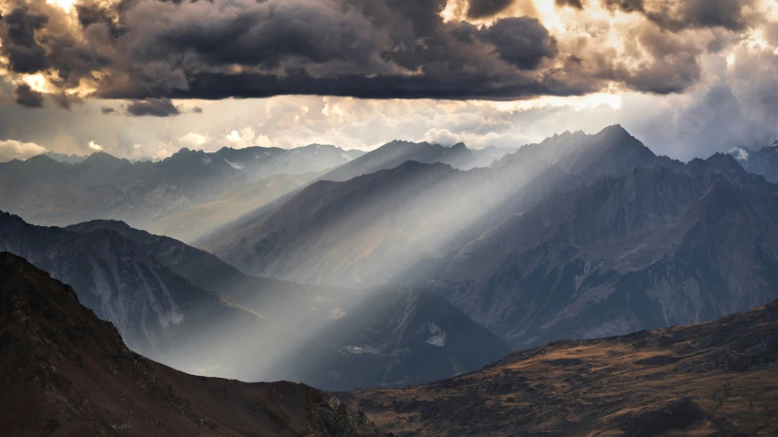 mountains with many shadows as the sun breaks