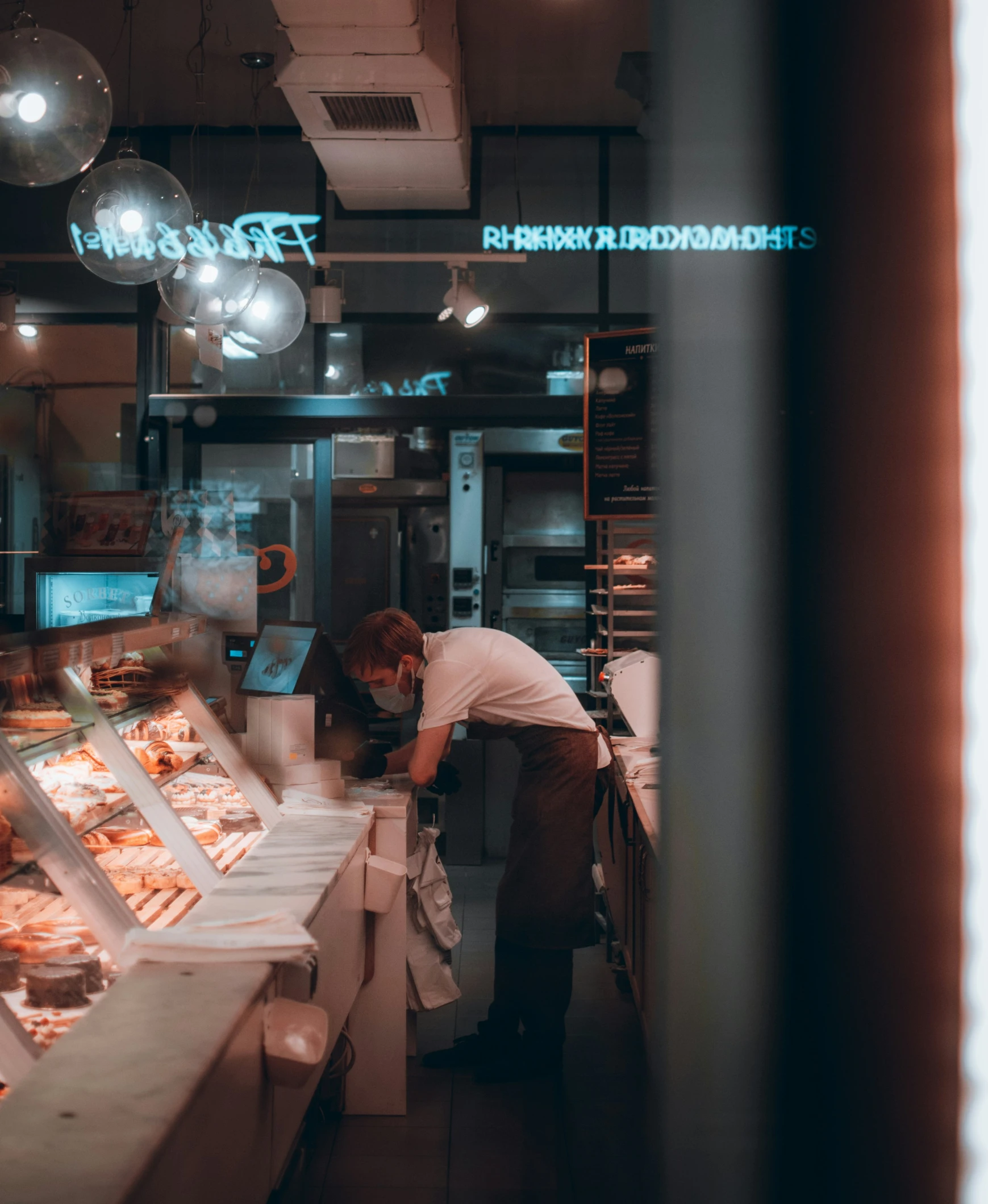 a person working in a restaurant cooking on a grill