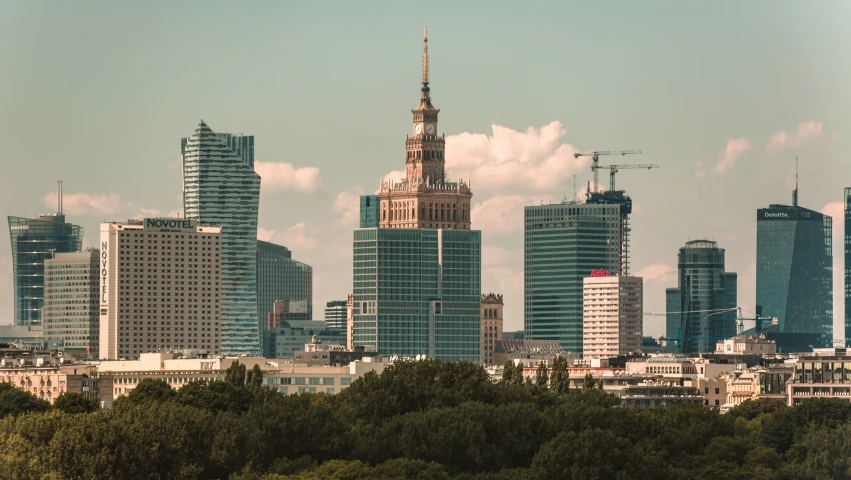 a tall city with lots of buildings and trees