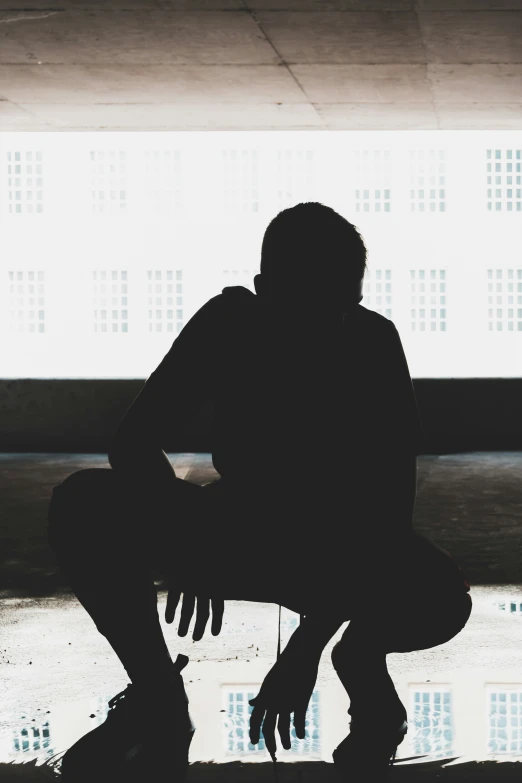 a black and white po of a person holding a skateboard