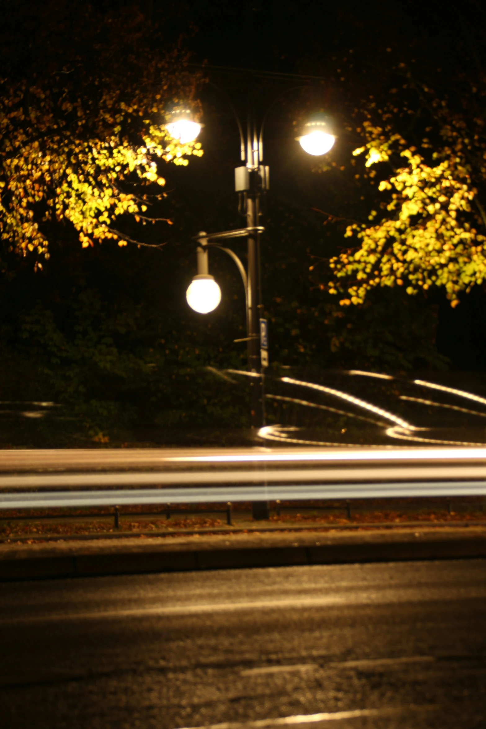 a street light sitting over a dark street