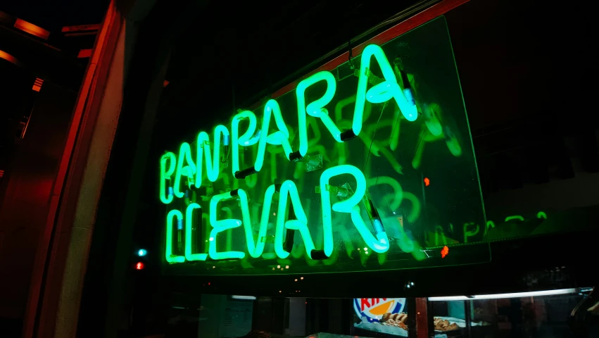 a sign lit up in the dark by lights