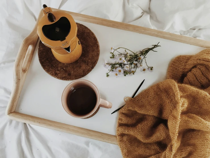 a bed is shown with two cups of coffee