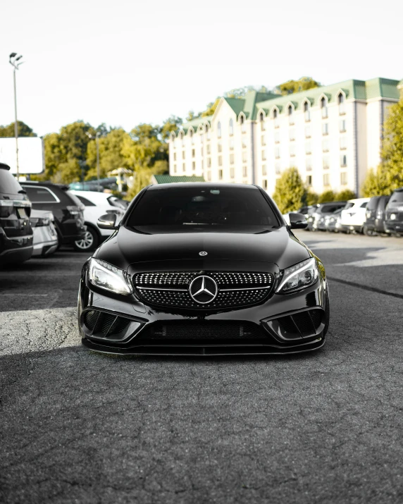 the mercedes benz coupe car sits in a parking lot