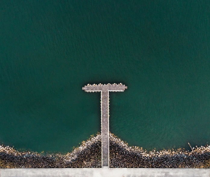 aerial view of a pier in the water at the beach