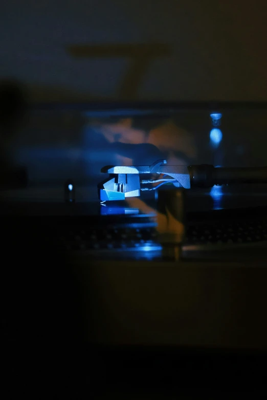 a person holding a camera, with dark lighting on the background