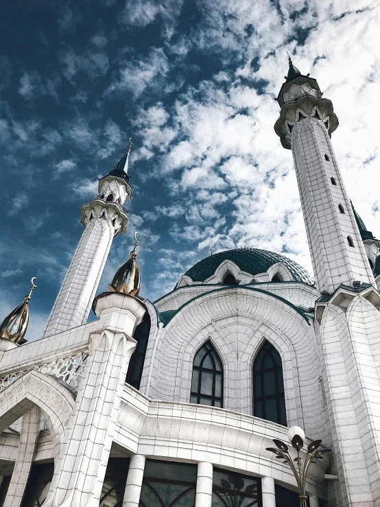 the front view of a white building with two towers