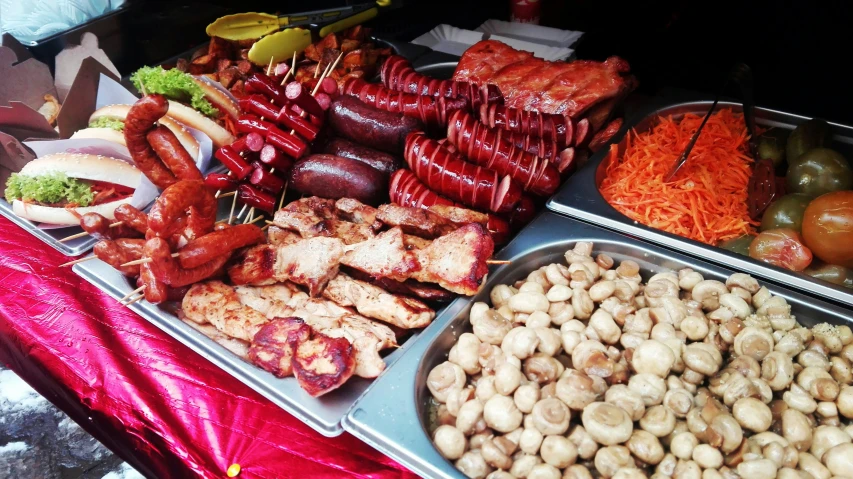 the meats and vegetables are neatly arranged in trays