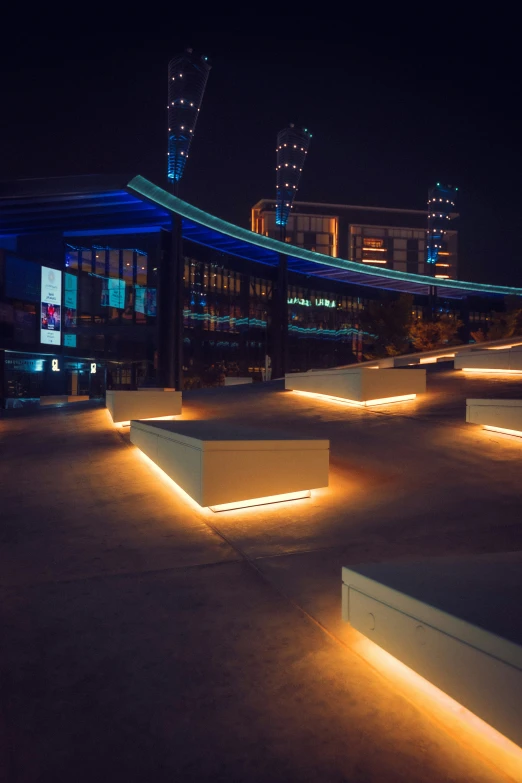 lit up concrete benches in front of a building