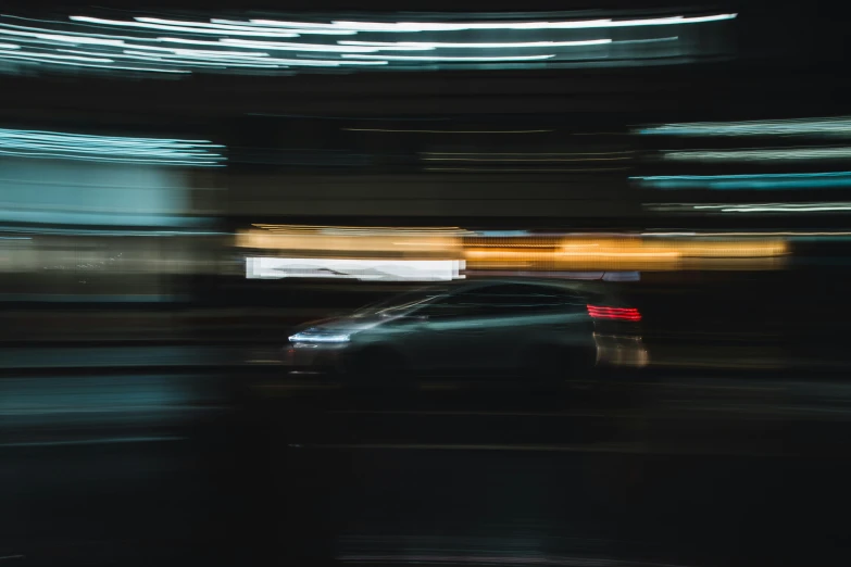 cars driving on a city street at night