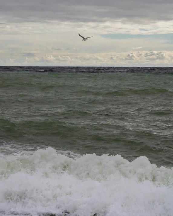 a small plane flying over the ocean water