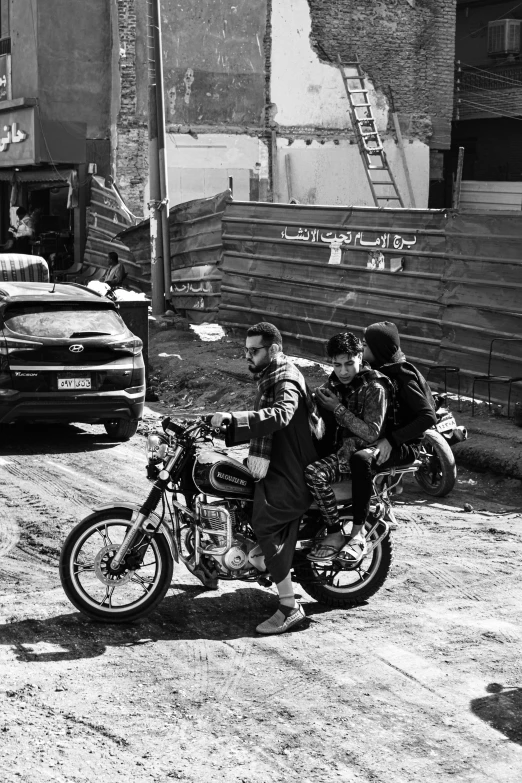 a black and white po shows two men riding a motorcycle